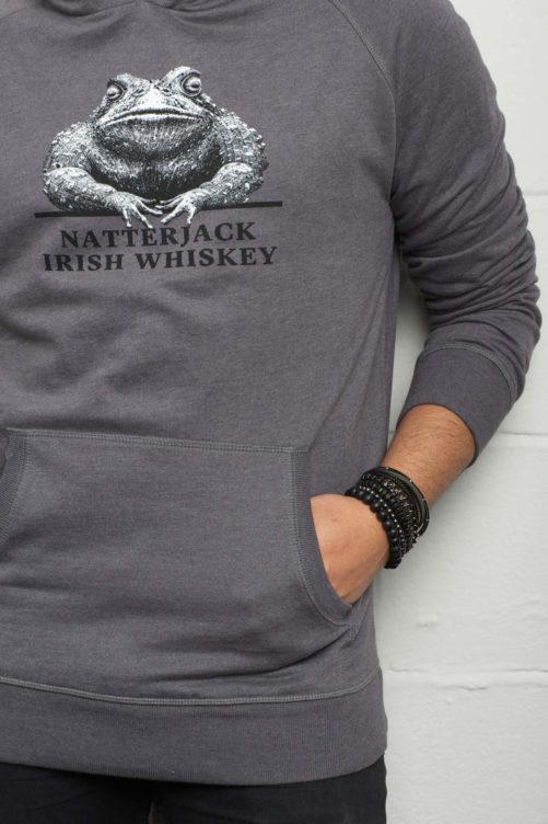 Man-Standing-Wearing-Grey-Natterjack-Whiskey-Hoodie-Logo-Detail