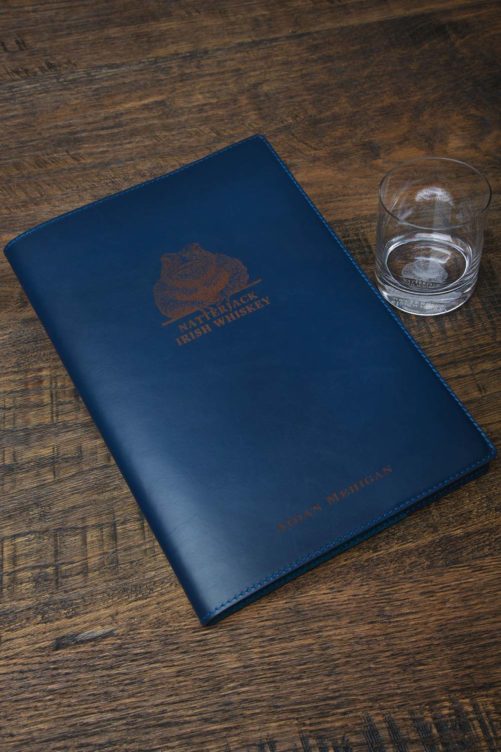 Natterjack-Irish-Whiskey-Blue-Notebook-beside-Whiskey-Glass